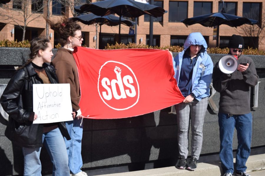 Students for a Democratic Society protest in front of Risman Plaza Tuesday. Lucas Fratianne led the group in chants. 