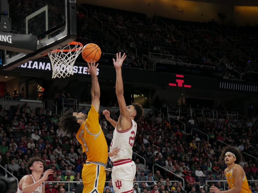 Sincere Carry (left) weaves a difficult la-up past defender Trayce Jackson-Davis (center right) at Kent State's March Madness matchup against Indiana Mar. 18.