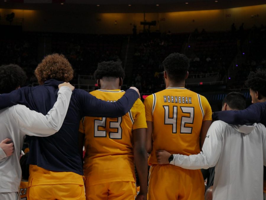 Kent State players embrace during a timeout at Kent State's March Madness matchup against Indiana March 17.