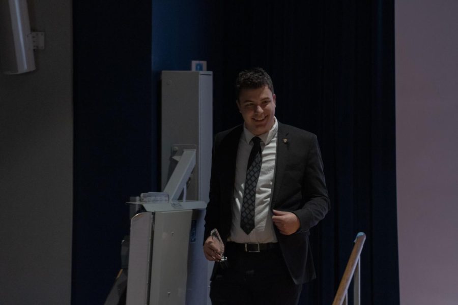 Nathan Jagodzinski, a member of Sigma Chi, leaves the stage after collecting his award for being the FSL Man of the year on March 21, 2023.