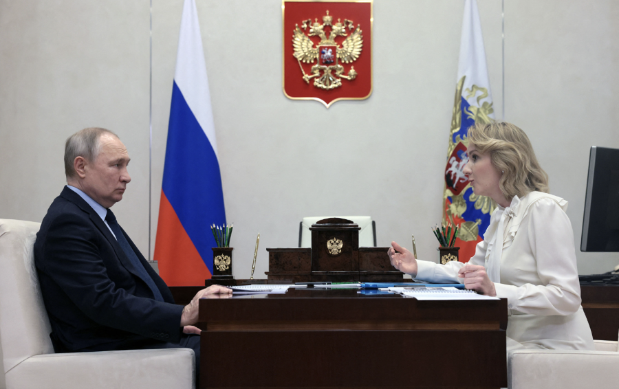 Russian President Vladimir Putin meets with Maria Lvova-Belova, Russian children's rights commissioner, at the Novo-Ogaryovo state residence, outside Moscow, Russia, on February 16. (Mikhail Metzel/Sputnik/ AFP/Getty Images)