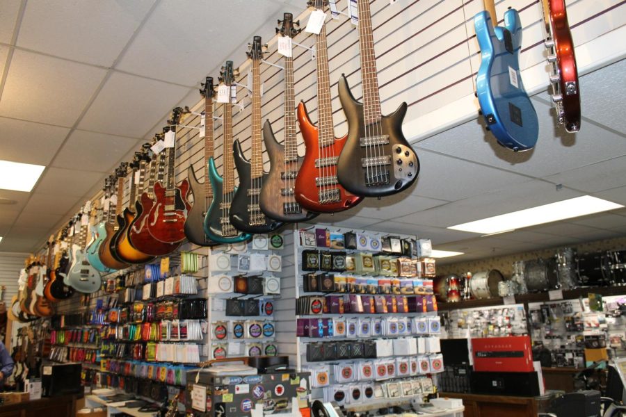 Electric guitar's for sale display inside Woodsy's music store.