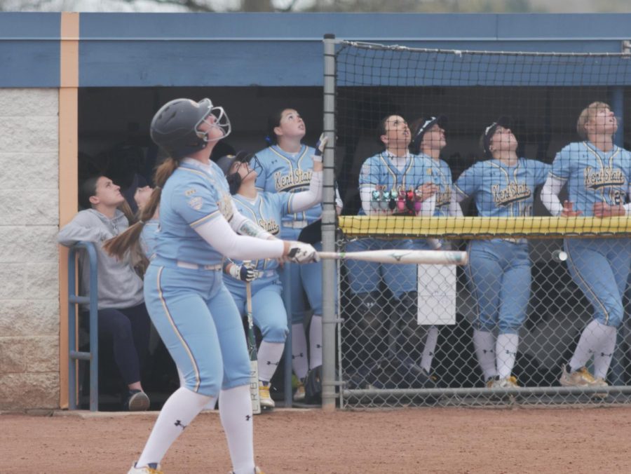 Emily Lippe (left) follows her foul ball alongside her teammates in the dugout during Kent State's game against the University at Buffalo Apr. 25.