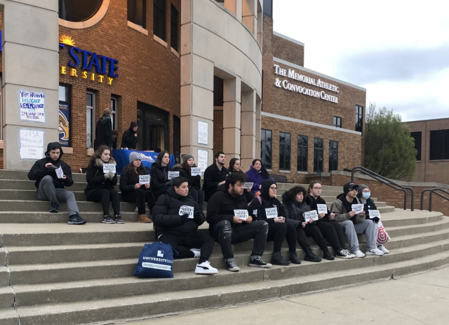 Students sit on the steps of the MACC in honor of Holocaust Remembrance Day.