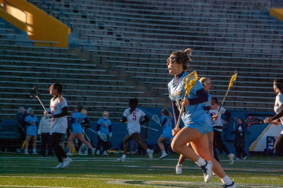 Women's lacrosse player Megan Cook makes her way toward the goal during the game against Delaware State on March 8, 2023. 