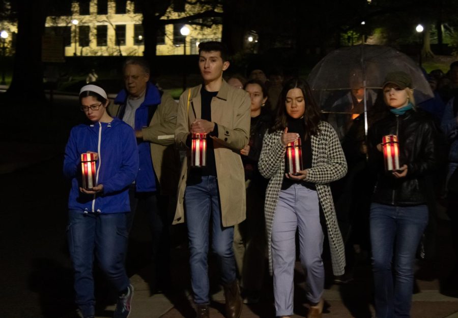 Leaders of the Kent State Candlelight Vigil holding four candles in honor of the lives lost May 4, 1970.