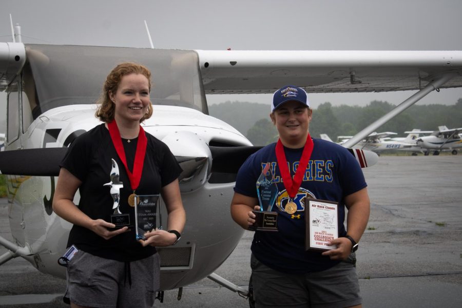 Pilots Laura Wilson (left) and Peyton Turner (right) pose with their trophies in front of their plane after returning from winning this year's Air Race Classic. 