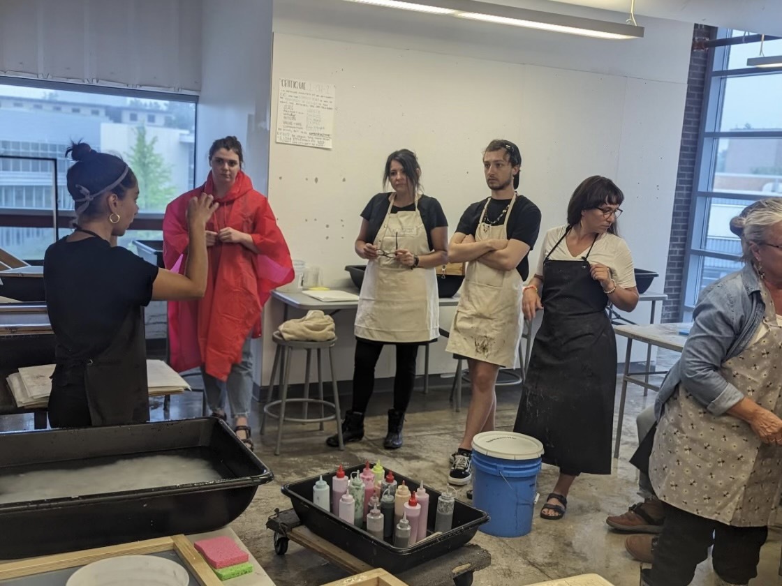 Printmaking Faculty Leigh Garcia (left) hosts "The Art of Papermaking" workshop while participants current Kent State Art Education student Audrey Larlham, recent Art Education graduate Joann Duran, Art Education Alumnus Jordan McConnell, Erin Duffy and Suzanne Mitolo listen. (Courtesy of symposium chairs)