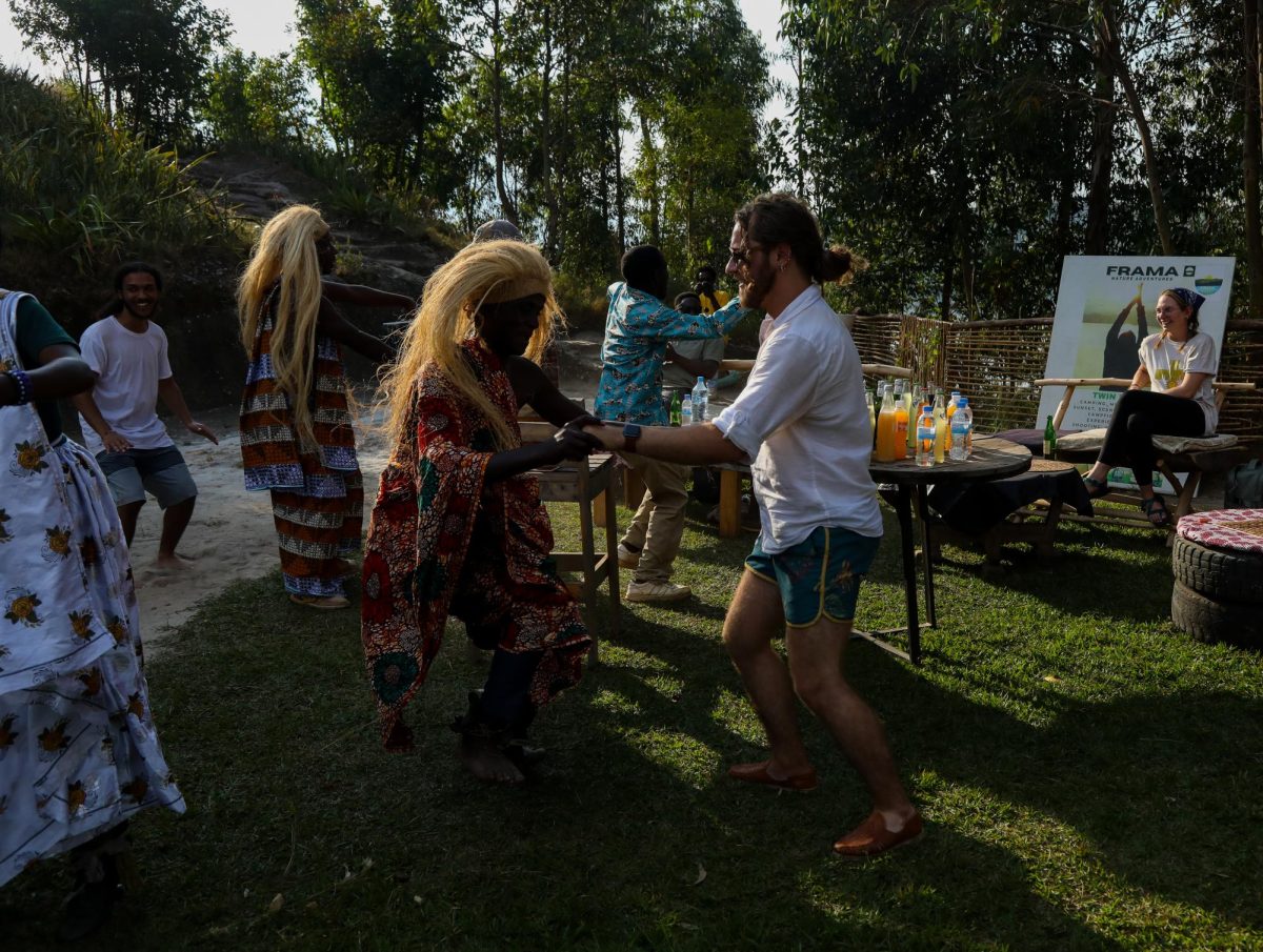 Jordon Egbert, Kent State higher education masters students, stands to participate in African cultural dance at Twin Lakes, Rwanda.