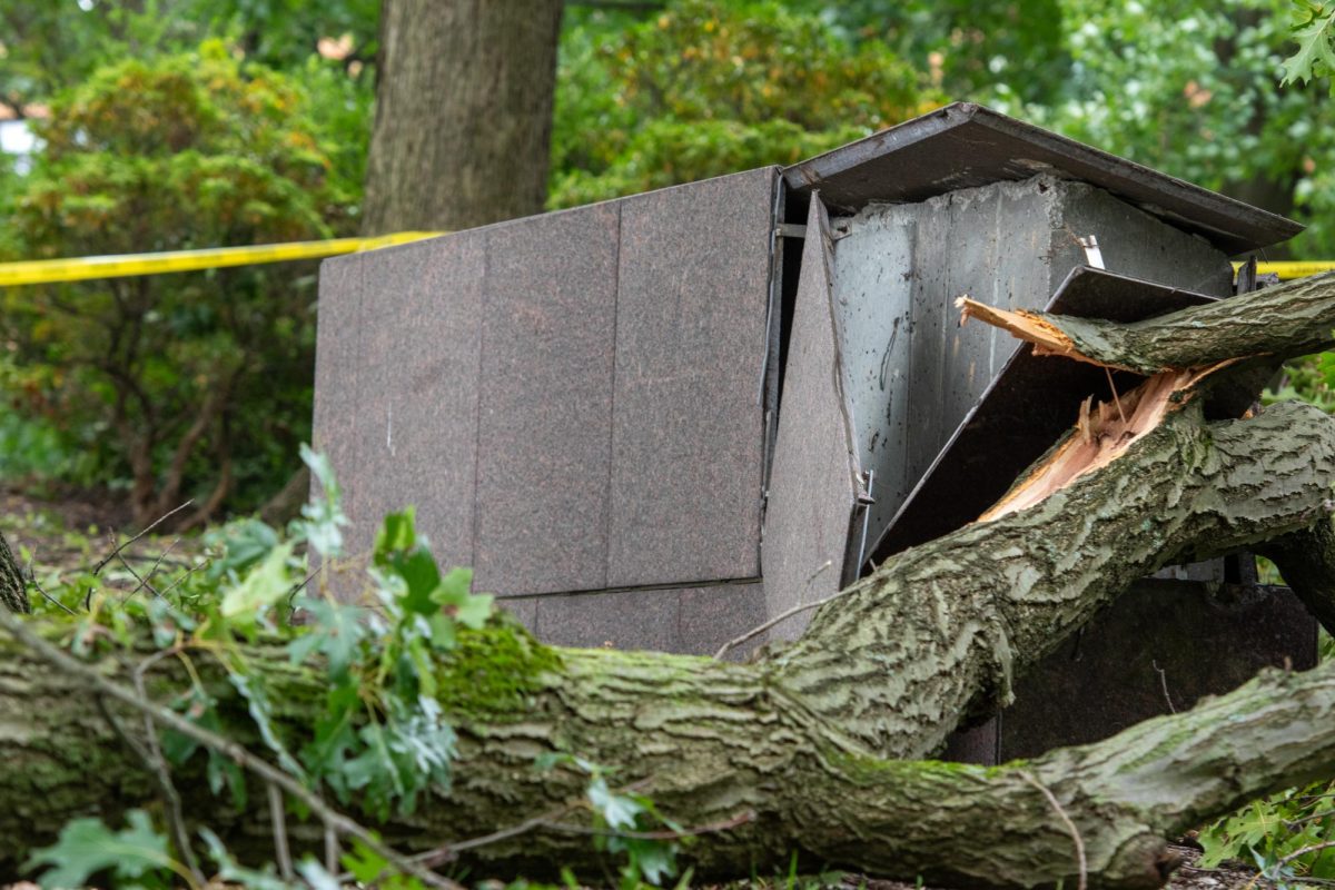 This stone monument, part of the May 4th Memorial exhibit, stands with its side cracked open by a falling tree in the aftermath of a severe thunderstorm on Aug. 25, 2023.