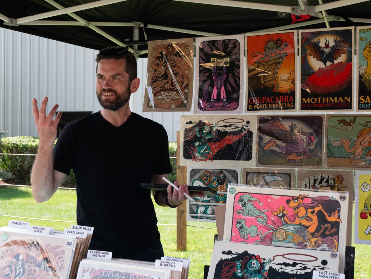 Randy Crider vends his art outside MadCap Brew Co. in Kent during Main Street Kent's Crafty Crawl Aug. 27, 2023