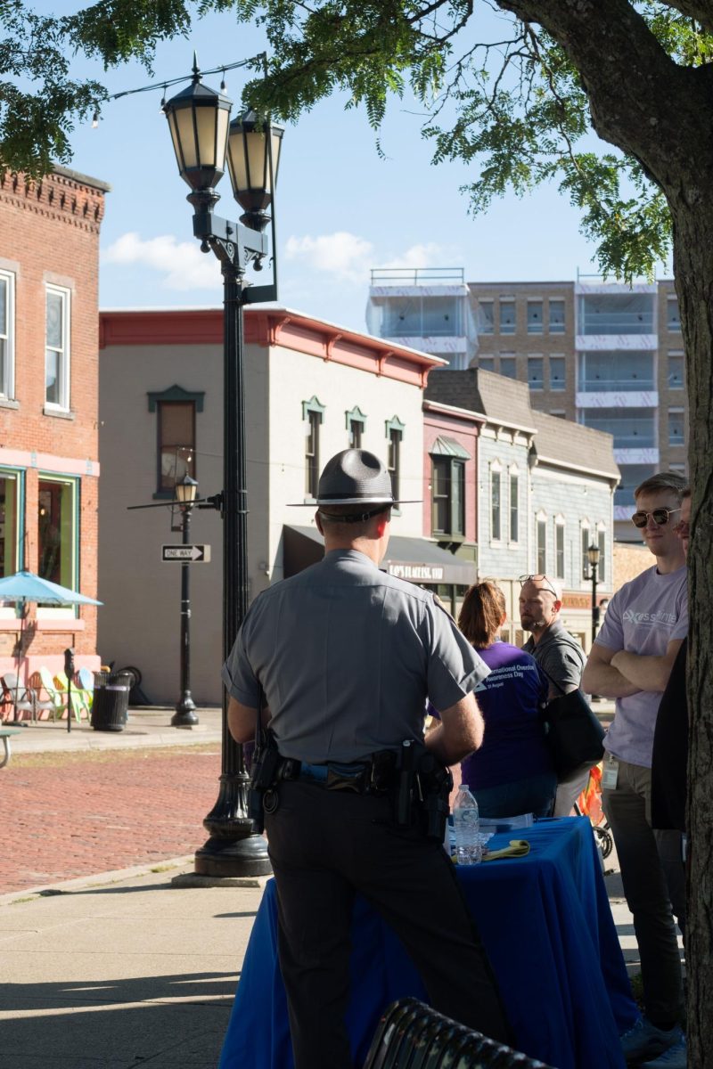 Kent police officer talks to attendees at the Overdose Awareness Event at the Downtown Kent Gazebo on Aug. 31.