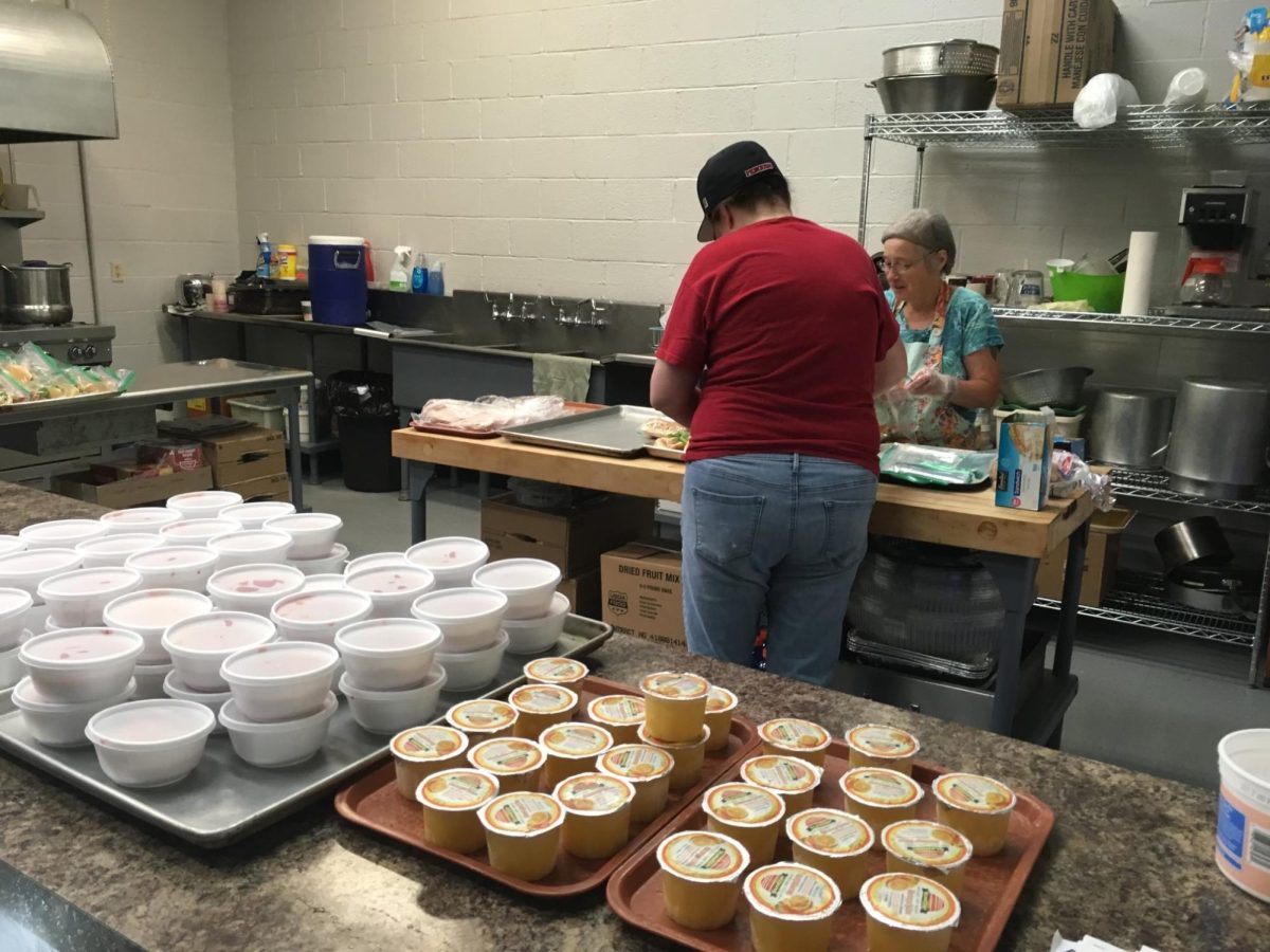 Two people help prepare food for Lovelight's Summer Meal Delivery program, where the nonprofit provided meals to children ages 18 and under around the community. 