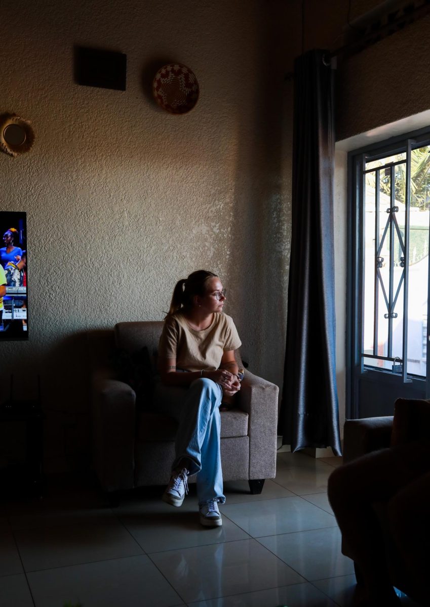 Lily Keister, Kent State higher education master’s student, looks out the window in Pacifique Niyonzima’s living room. Pacifique invited us to his house for dinner on one of the last nights of the trip.