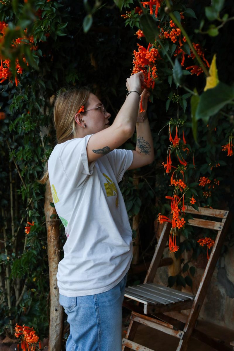 Lily Keister, Kent State higher education master’s student, picks honeysuckle outside of her room at Akagera National Park.