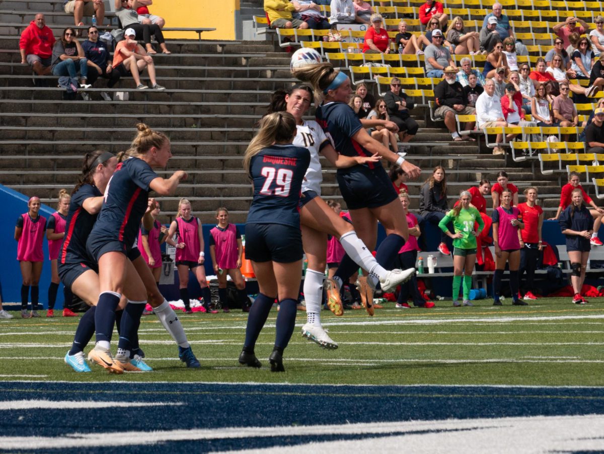 Giulia Giovinazzi (center) headers a ball away from Duquesne defenders at Kent State's senior day matchup against Duquesne Sep. 10, 2023.