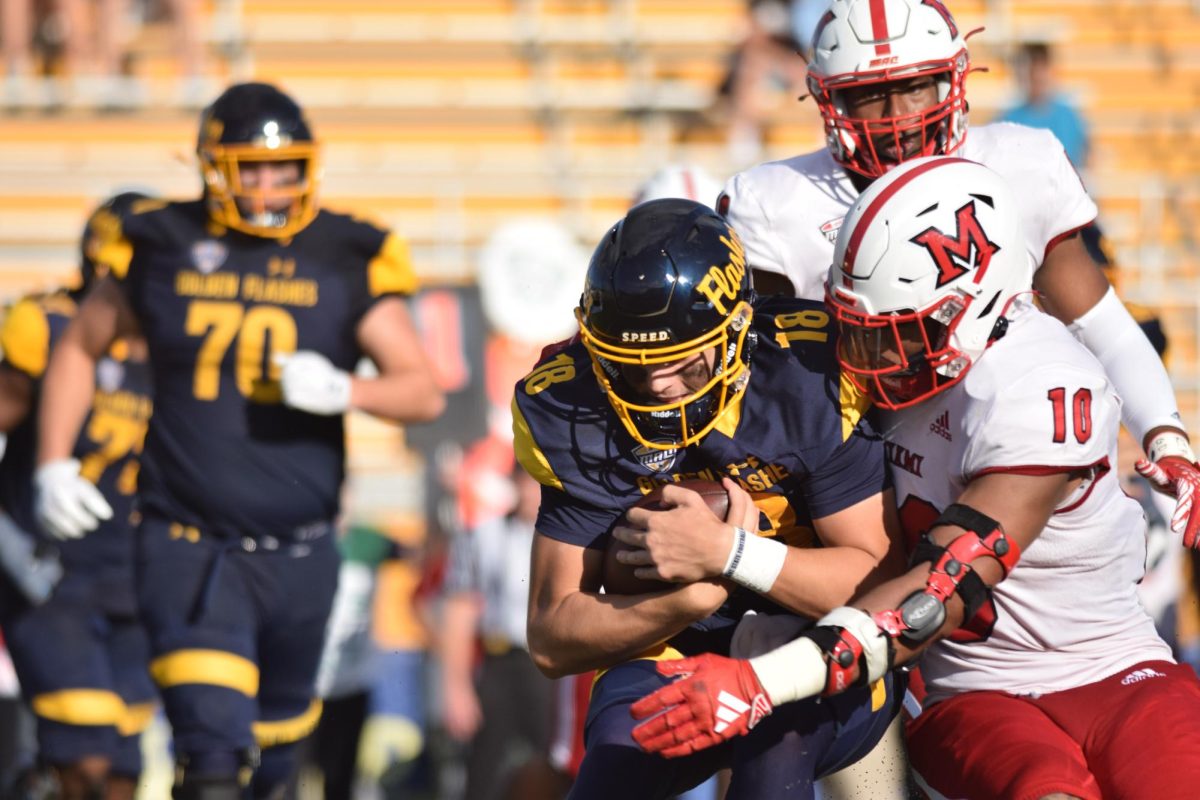 Redshirt junior Michael Alaimo, Kent State's quarterback, protects the ball from the Miami University defense on Sept. 30, 2023.