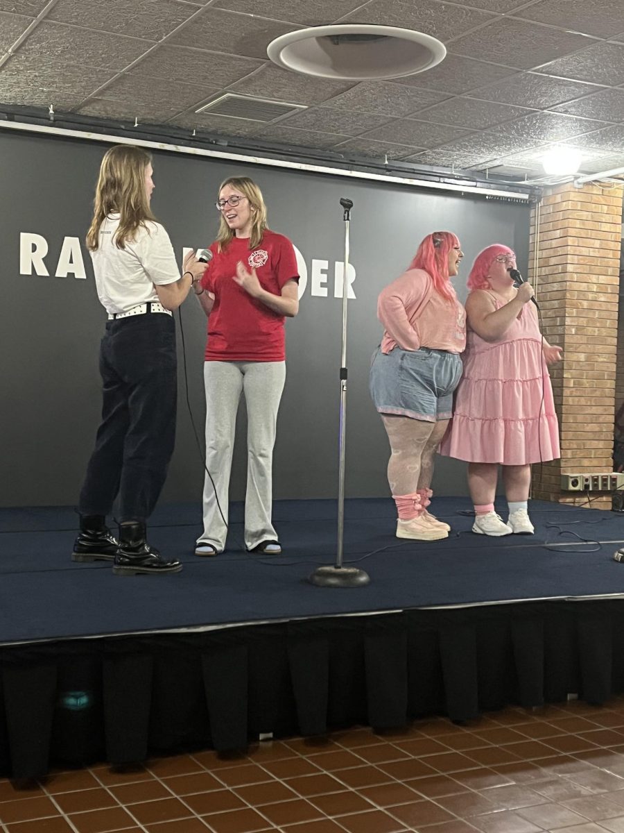 Attendees stand on stage singing their favorite tune during FAB's karaoke event on Sept. 13, 2023.