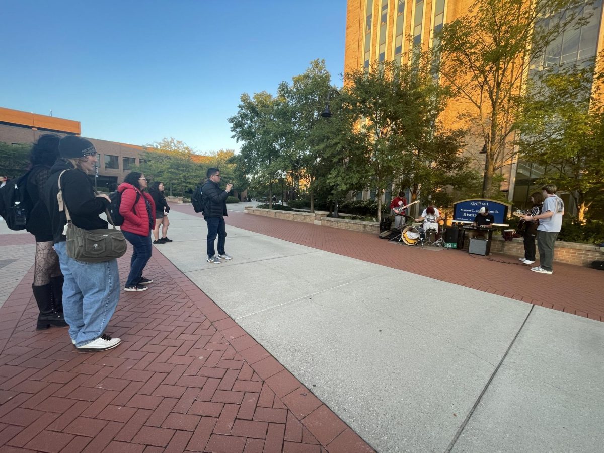 Students enjoy live music from the band Sunset Drive outside the library