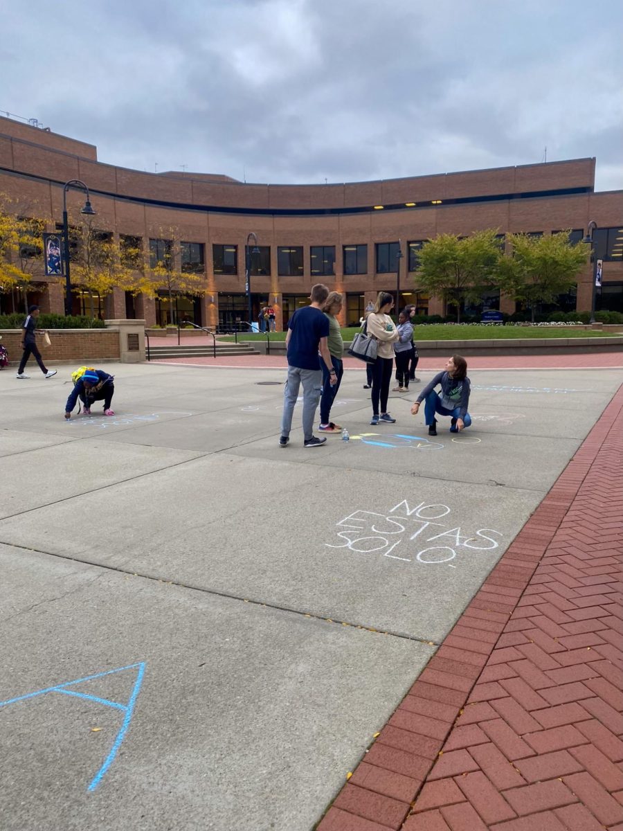 Students use chalk to write messages on the Risman Plaza during Active Minds at KSU's suicide awareness walk on Sept. 26, 2023.