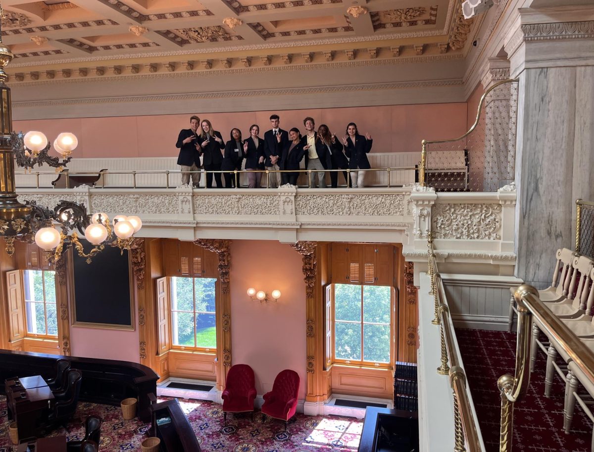 Students attending Kent State's Columbus Program in State Issues stand in the Senate Chamber room of the Ohio Statehouse building in Columbus. 