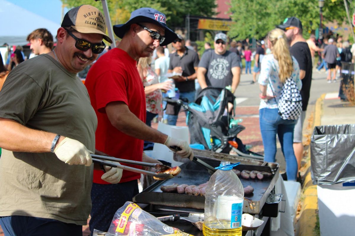 Members of the Kent Fire Department prepare bratwursts for costumers at Main Street Kent's Oktoberfest on Sept. 23, 2023. 