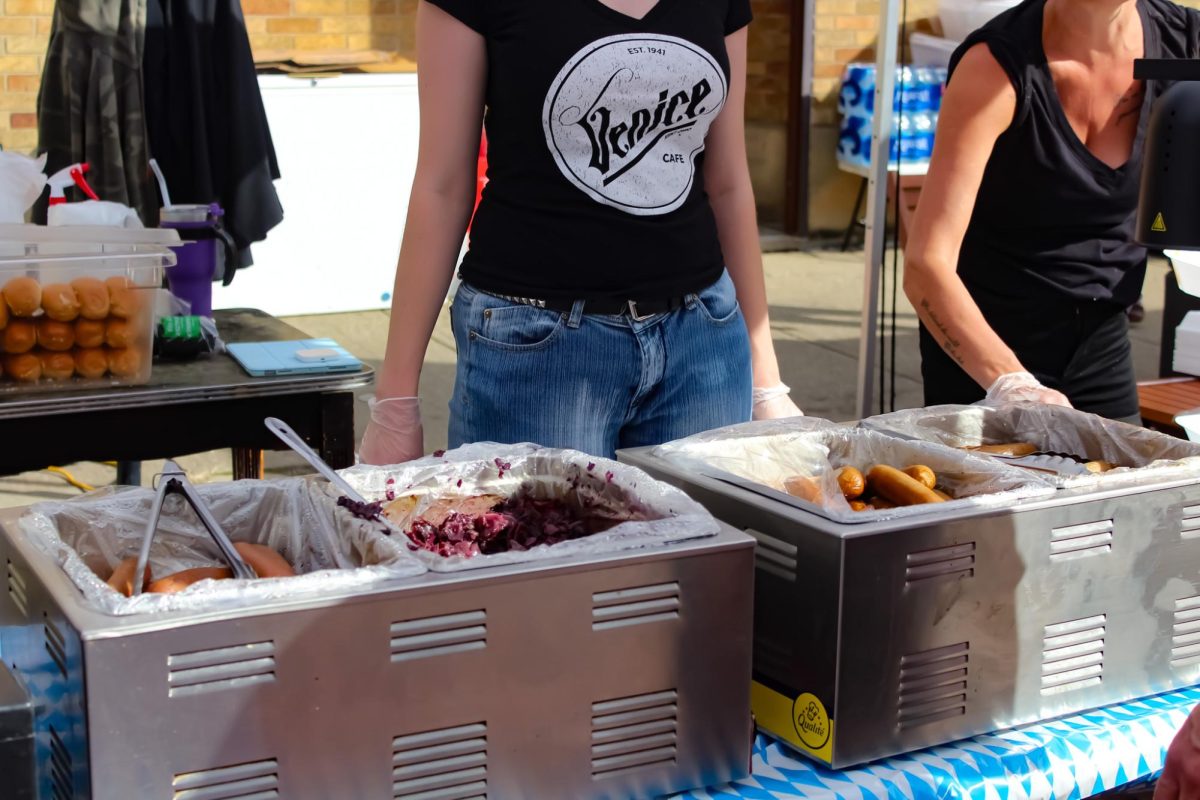 Employees at the Venice Cafe serve German inspired dishes at Main Street Kent's Oktoberfest on Sept. 23, 2023.  