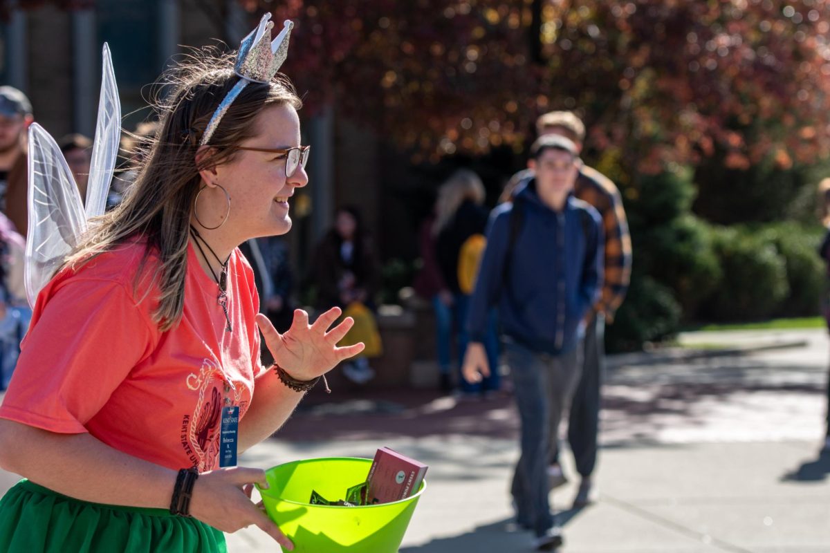 Kent State senior Rebecca Nugent, dressed as the Condom Fairy for the third year in a row, passes out condoms on the K on Oct. 23, 2023.