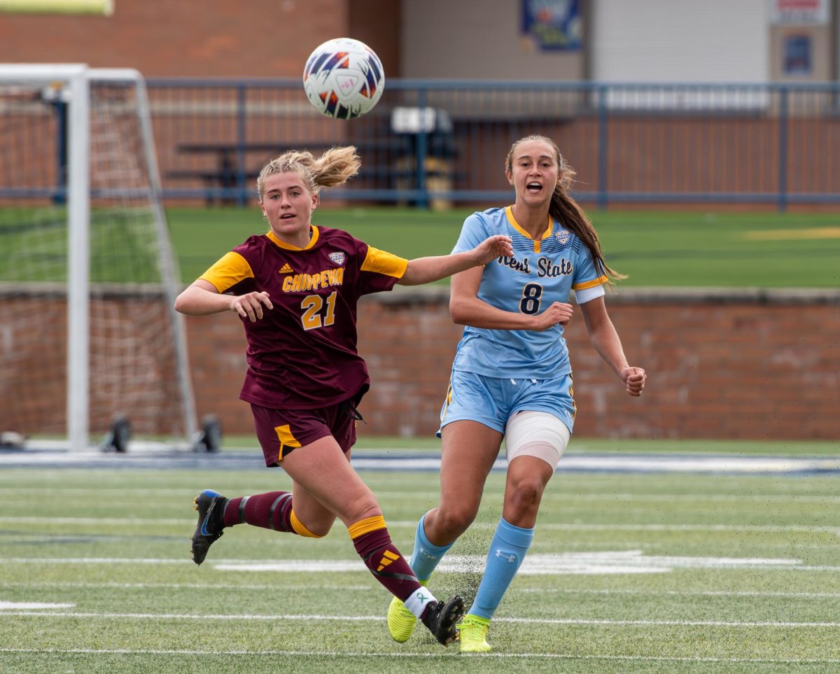 Kent State senior Dalaney Ranallo beats CMU graduate student Claudia Muessig to the ball and launches it up field during the game against CMU on Oct. 8, 2023.