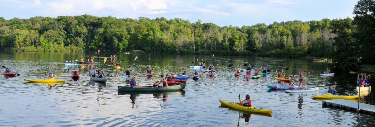 A group kayaks in local river. 