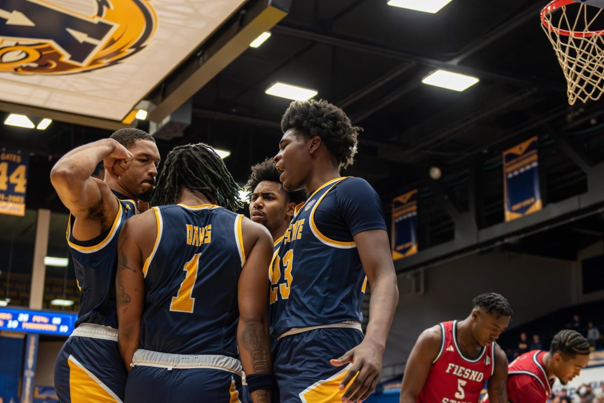 Kent basketball team players celebrate as they pull further ahead of Fresno State during the game on Nov. 11, 2023. 