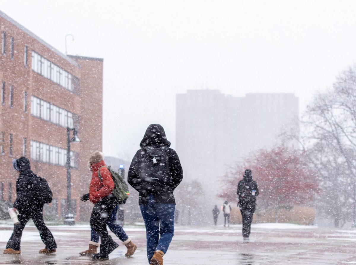 Kent State students walk through heavy snowfall as they make their way along the Esplanade.