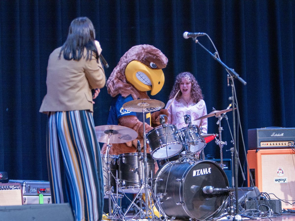 Flash, the beloved Kent State mascot, takes the drumsticks and shows off his rock skills before The Pit Crew's set at Flash Activities Board's "Battle of the Bands" event on Nov. 4, 2023.