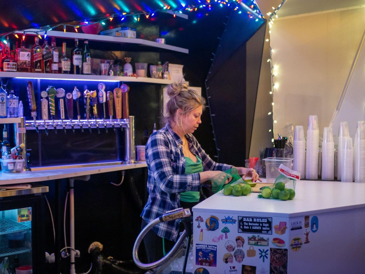 Bartender Stephanie Pullella cuts limes in preparation for the daily opening at Bar Lucci on Nov. 18, 2023.