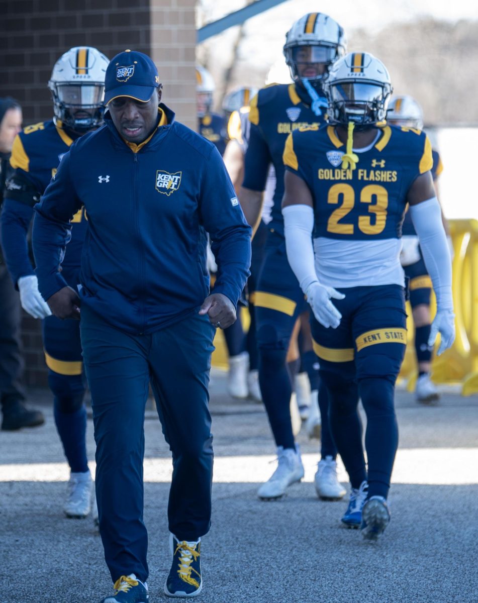 Head coach Kenni Burns leads the team to the tunnel before the Northern Illinois game on Nov. 25, 2023.