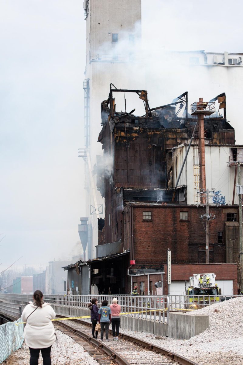 Several hours after the initial blaze, the section of the mill that endured the brunt of the fire continues to smolder on Dec. 2, 2022.