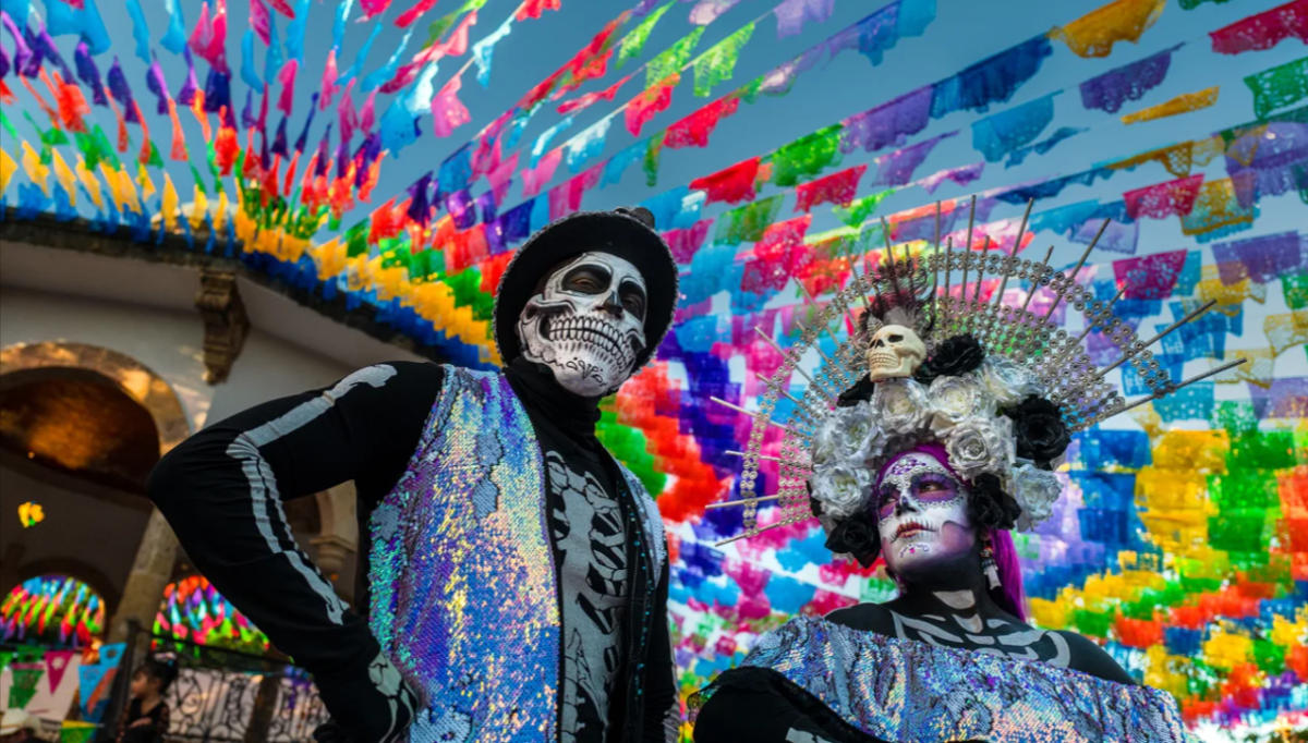 A young woman, dressed as La Catrina, and a young man, dressed as Catrin, particpate in the Day of the Dead festivities on October 31, 2022 in Jalisco, Mexico.