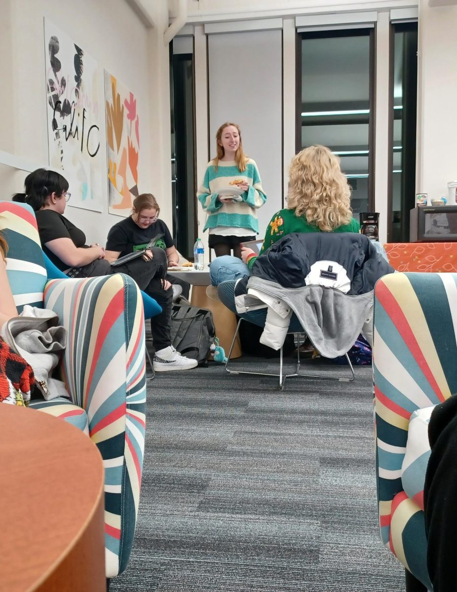 Students hanging out in the Taylor Hall Undergraduate Studio before the AIGA "Wrap up the Semester" event on Dec. 6, 2023. 