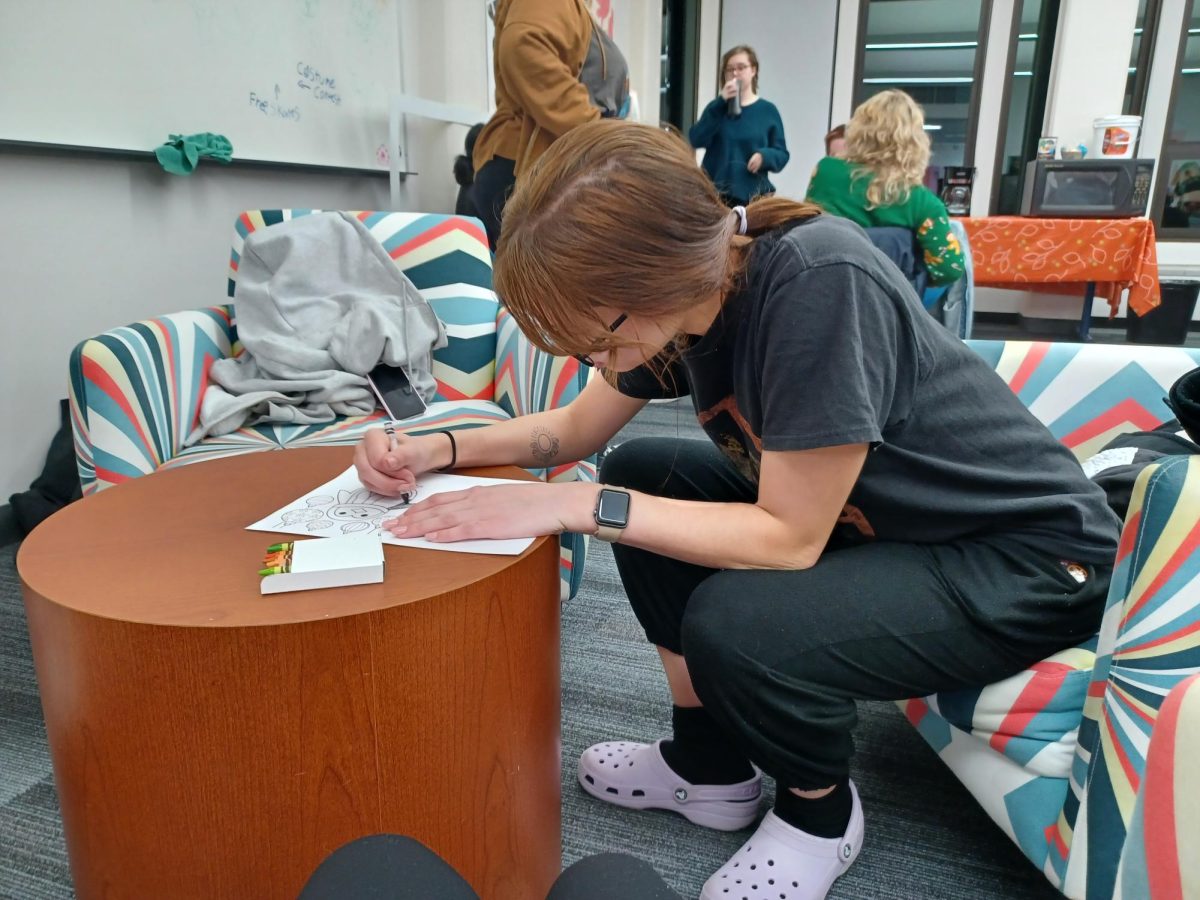 CCI student Alexandria Radde coloring cards during the AIGA Design event "Wrap Up The Semester" on Dec. 6, 2023.