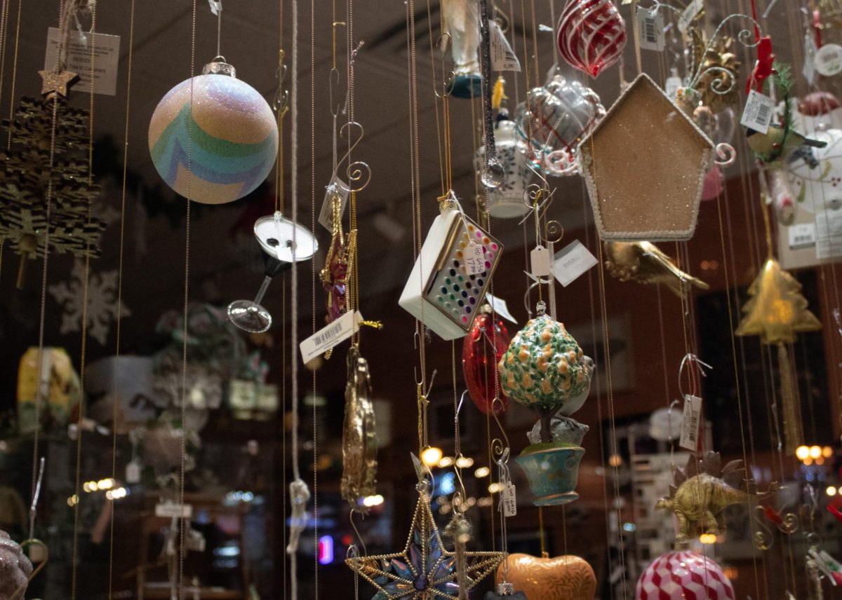 Christmas ornaments are displayed in McKay Bricker Framing's store windows. 