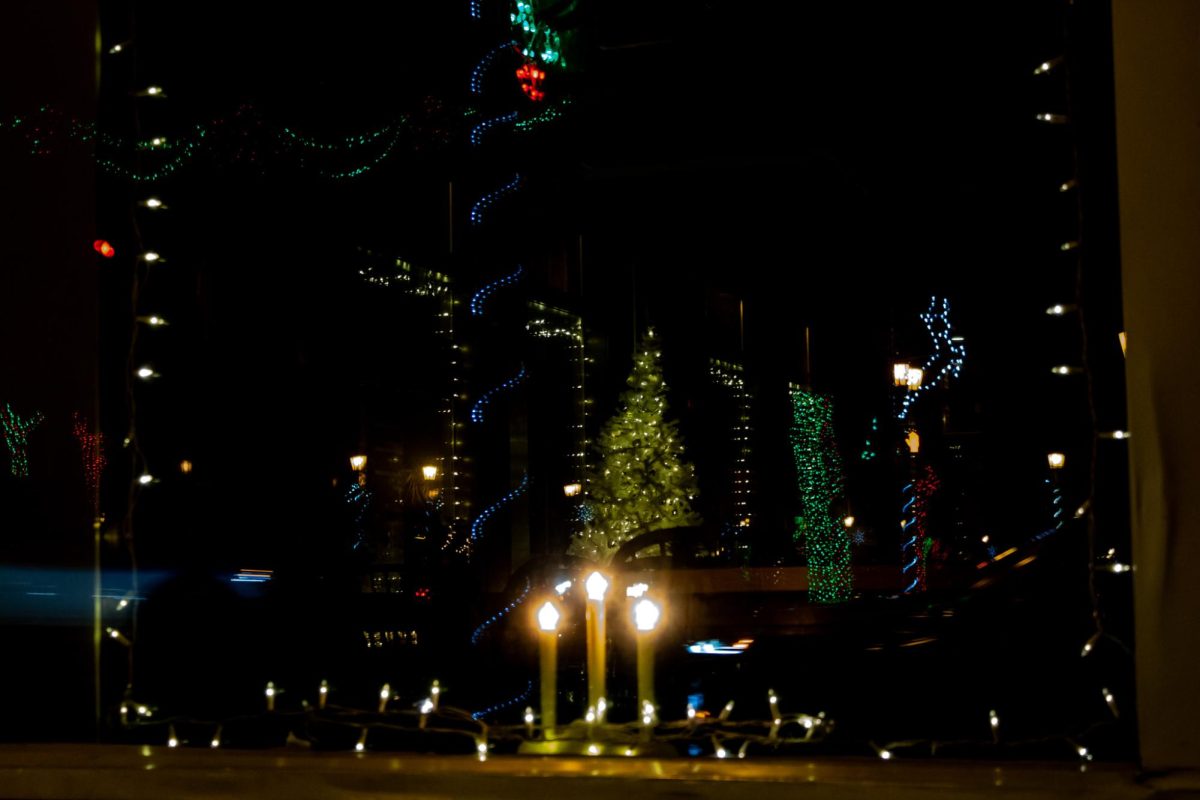 Festive light displays in downtown Kent reflect off of Franklin Square Deli's store windows.