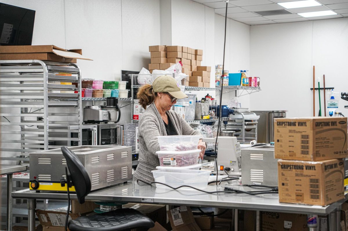 Marcie Haymaker "Pop Manager" putting supplies away for the night on January 31, 2024.