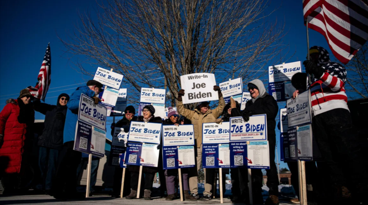 Attendees hold signs during a Write-In Joe Biden campaign "Get Out The Vote" event in Dover, New Hampshire, US, on Sunday, January 21, 2024.
