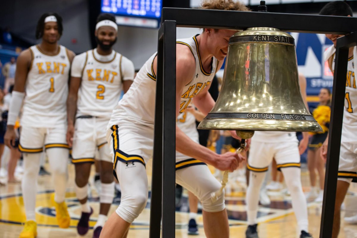 Sophomore Magnus Entenmann rings the bell after the basketball team's victory against Buffalo on Feb. 27, 2024.