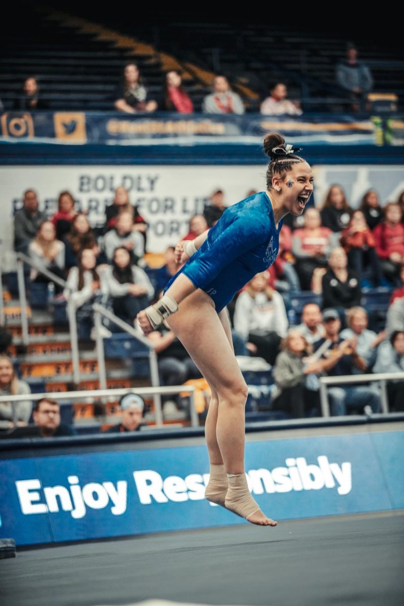 Graduate student Karlie Franz celebrates after her floor performance against Northern Illinois.