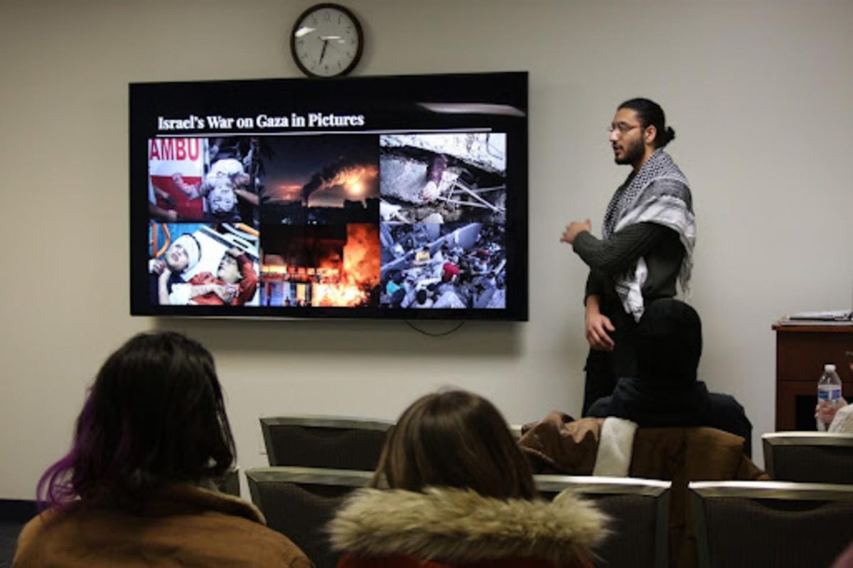 Yaseen Shaikh, President of Students for Justice in Palestine, presents photos from the ongoing war in Gaza at the SJP's event titled “Let’s talk about Gaza,” which took place at the KSU Student Center on Feb. 15, 2024.