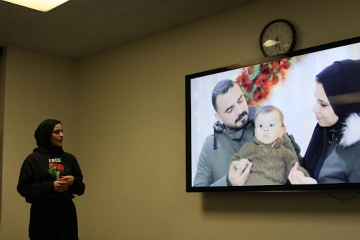 Sabreen Alshaikh, a graduate student from Gaza studying translation at KSU, presents photos of former friends and university colleagues and their families she had in Gaza who were killed in the war at the "Let's talk about Gaza" event on Feb. 15, 2024.