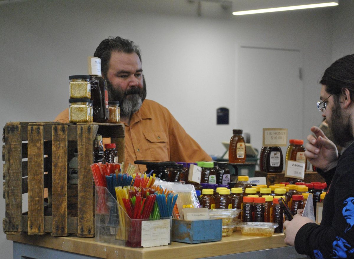 Matt Kline, owner of Kline's honey bee farm, displays honey at the farmers market held in the DI Hub on Feb. 20, 2024. 