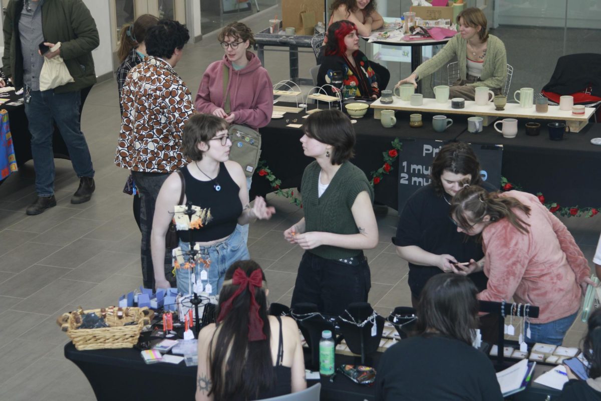 Students socialize and buy handmade art made by the Kent State University Art Club at their annual Valentine's Day sale Feb. 9, 2024 