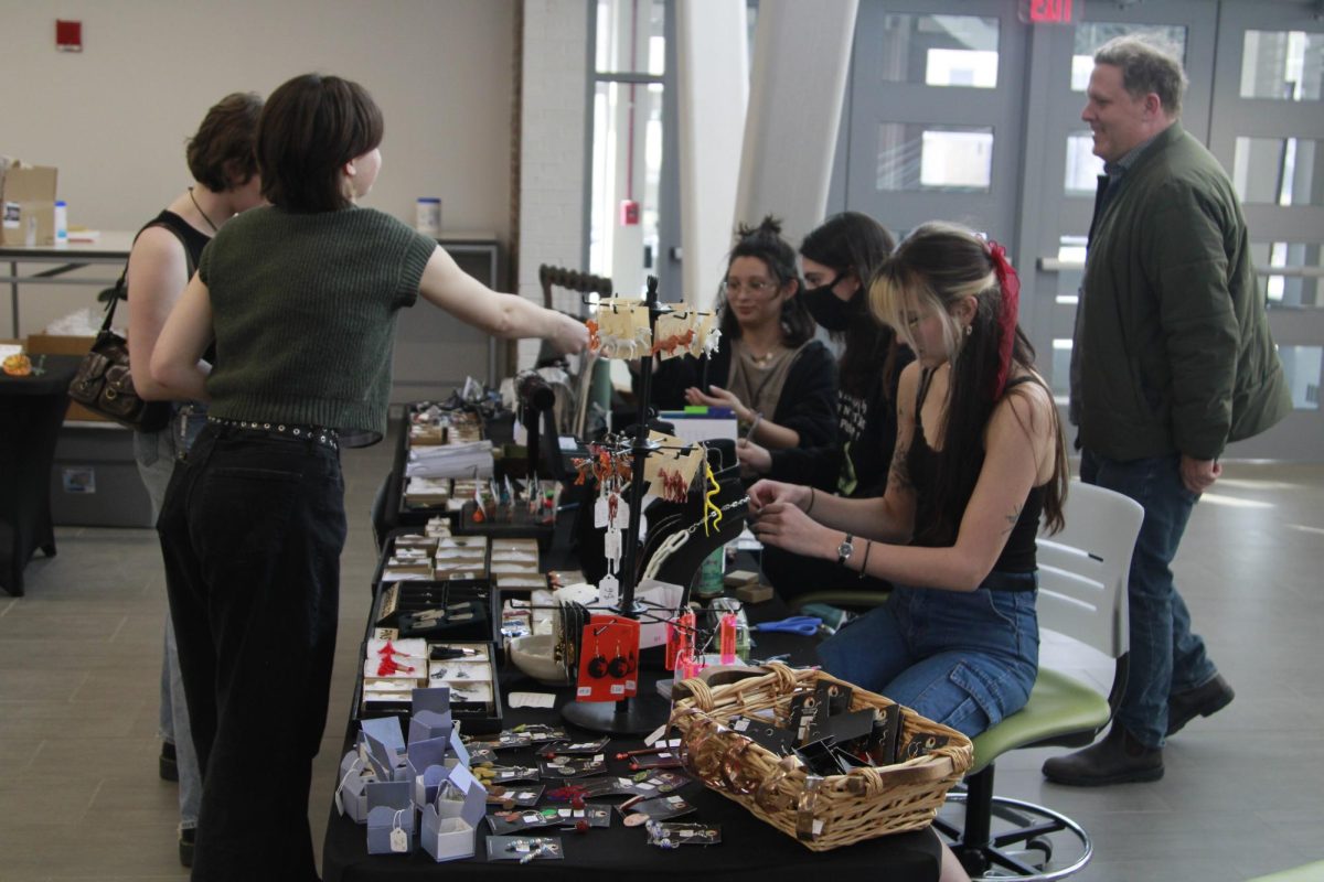 A student purchases handmade jewelry at Kent State Art Club's annual Valentine's Day sale Feb. 9, 2024 